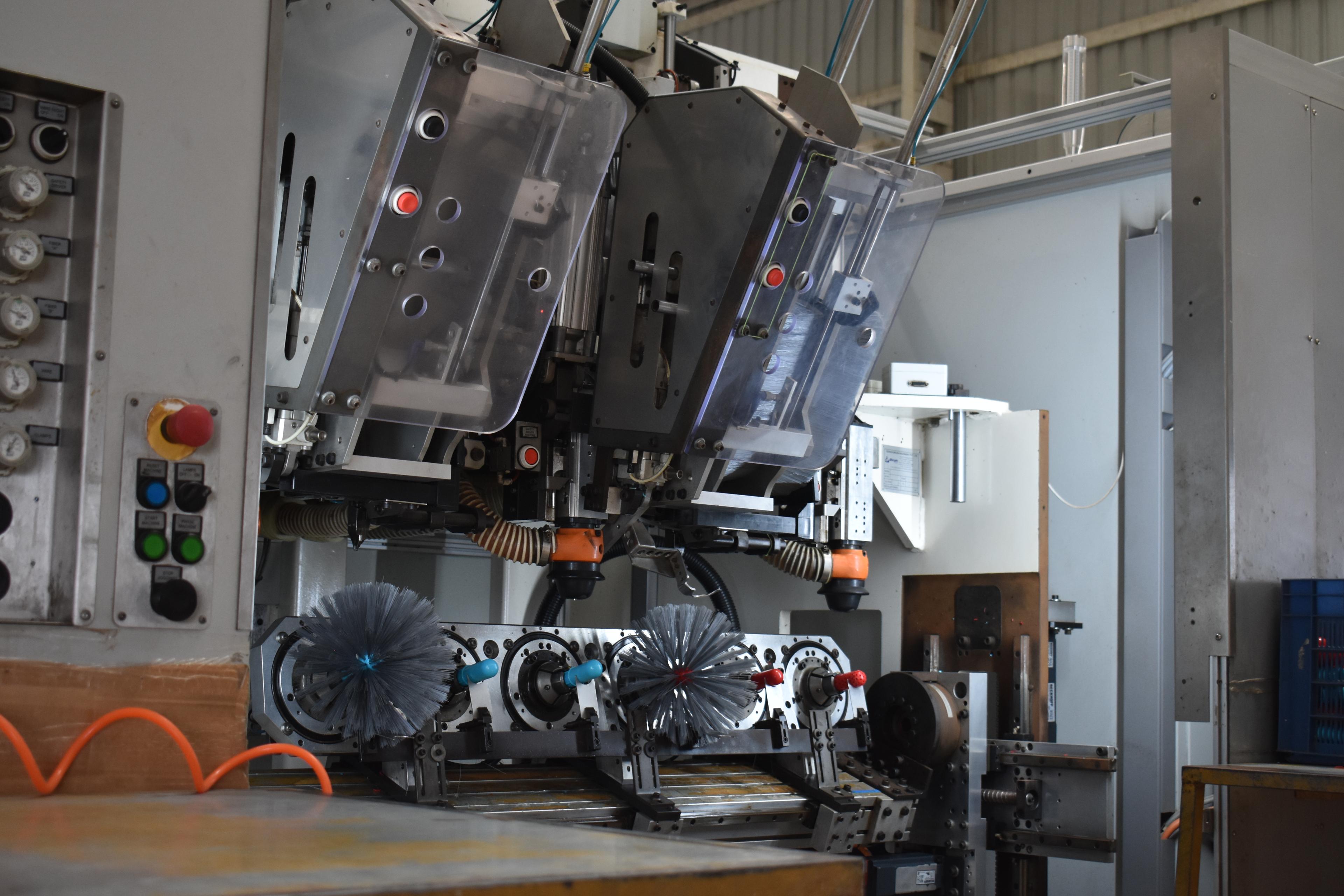 Brush manufacturing machinery with conveyor system